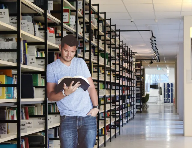 man, reading, library, book, leaning, study, research, student, person, male, teacher, learning, university, homework, shelves. How to read recommended books critically